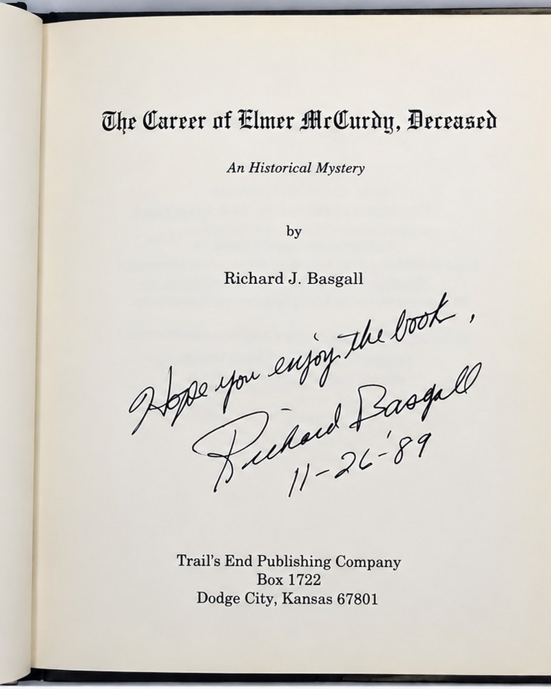 A book title page showing the title, author, publisher, and a handwritten signature